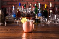 A copper mug sits on a table.