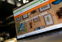 A laptop screen shows Idaho's Affordable Care Act marketplace website, with "Open Enrollment Ends December 15" in all-cap tyoe.