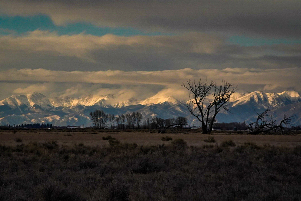 A landscape photograph of a mountain-scape in Colorado at sunset.