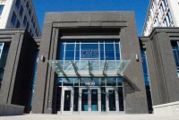 A photo of the front of a research building. A sign on the front reads, "National Cancer Institute."
