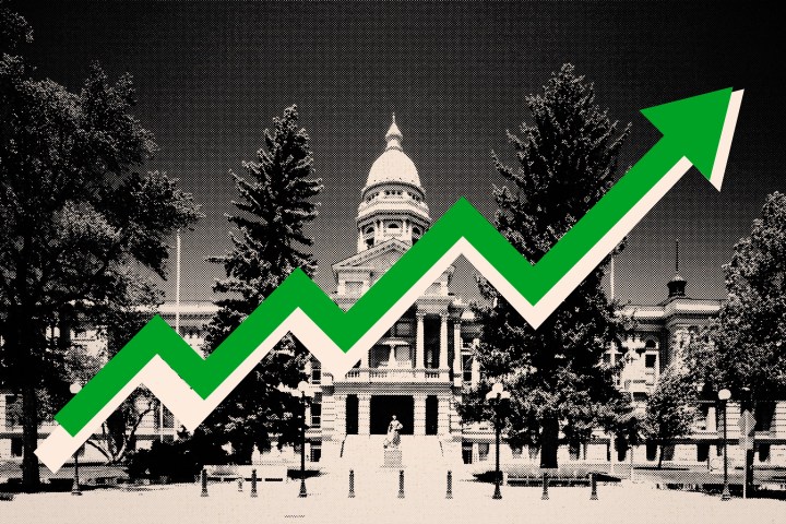 A photo illustration of the Wyoming State Capitol in black and white, with a green arrow pointing up across it.