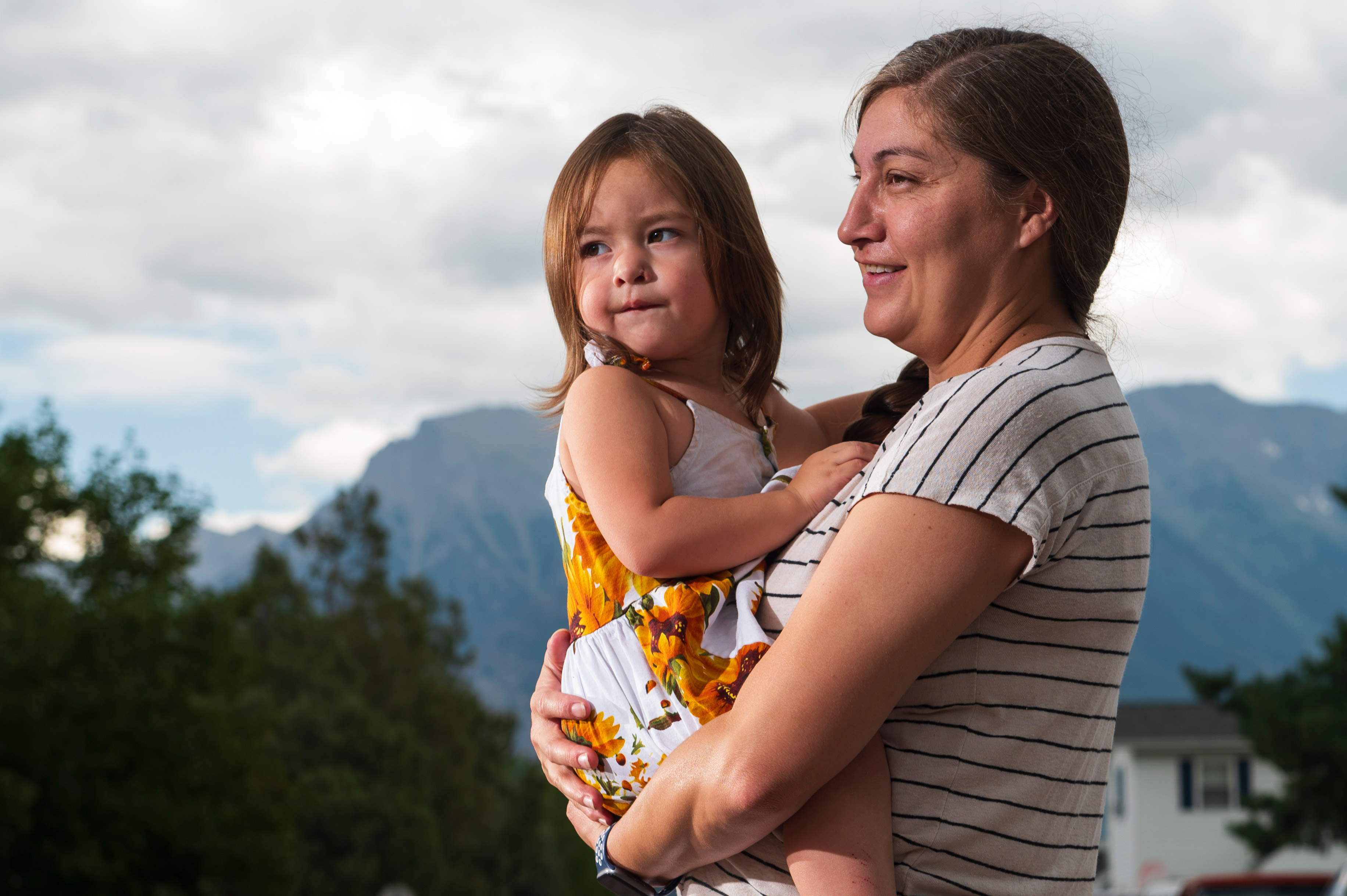 A photo of Jonnell Wieder holding her daughter outside.